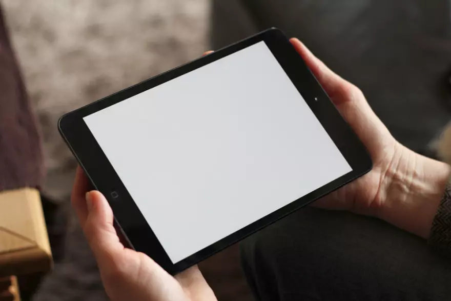 Download Mockup image of a tablet in human hands
