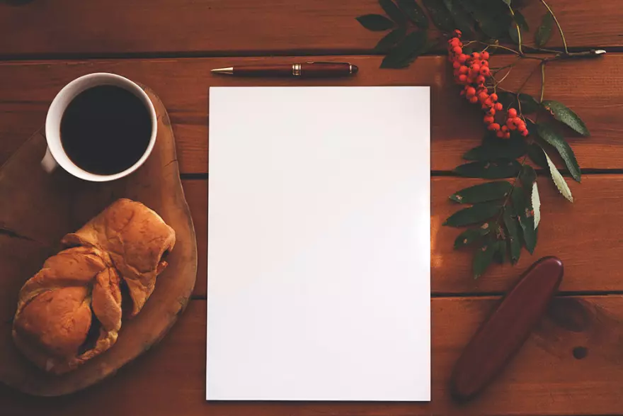 Download PSD mockup of a sheet of paper and a cup of coffee