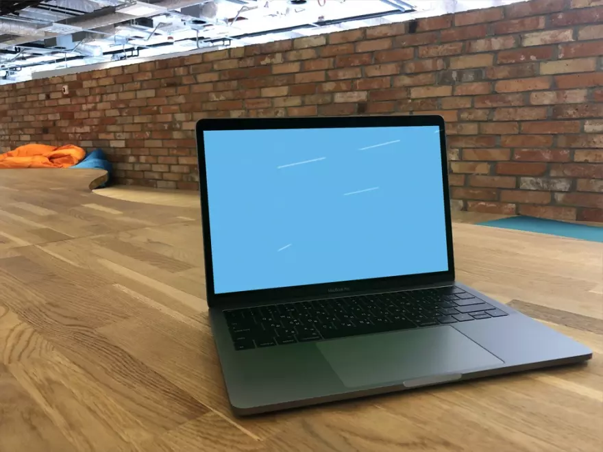 Download Macbook Pro mockup on wooden table