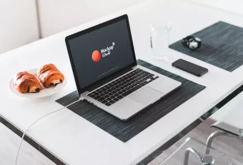 Macbook Pro mockup on a desk in an office PSD mockup