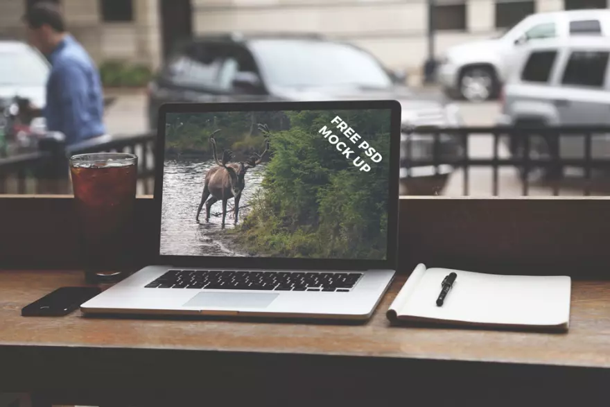 Download Laptop in a public place PSD mockup